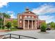 Smyrna City Hall featuring brick facade, clock tower, and well-maintained grounds under a blue sky at 160 Cricket Ln, Alpharetta, GA 30009