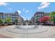 A fountain in a community space surrounded by multistory buildings at 160 Cricket Ln, Alpharetta, GA 30009