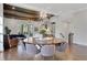 Open-concept dining area with a modern chandelier and views into the living room with hardwood floors at 160 Cricket Ln, Alpharetta, GA 30009