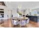 Open dining area with hardwood floors, modern light fixture, access to the kitchen, and plenty of natural light at 160 Cricket Ln, Alpharetta, GA 30009