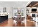 Elegant dining area with a round table, modern chandelier, and views of the living room and kitchen at 160 Cricket Ln, Alpharetta, GA 30009