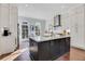 Bright kitchen with white cabinets, a black island with stone countertop, and stainless steel appliances at 160 Cricket Ln, Alpharetta, GA 30009