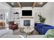 Charming living room features built-in bookshelves, a fireplace, a blue velvet sofa and updated modern decor at 160 Cricket Ln, Alpharetta, GA 30009