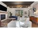 Spacious living room boasts hardwood floors, fireplace, and an abundance of natural light from the patio doors at 160 Cricket Ln, Alpharetta, GA 30009