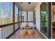 Inviting screened porch with comfortable seating, natural light, and private views at 160 Cricket Ln, Alpharetta, GA 30009