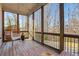Relaxing screened porch with wood floors, comfortable seating, and wooded views at 160 Cricket Ln, Alpharetta, GA 30009