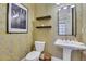 Stylish powder room with designer wallpaper, pedestal sink, decorative mirror, and chic lighting at 160 Cricket Ln, Alpharetta, GA 30009