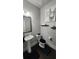 Cozy half bathroom with toilet and pedestal sink, accented by quirky wall art at 118 Reunion Pl, Acworth, GA 30102