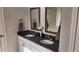 Bathroom vanity with double sinks, granite countertop, and decorative mirrors at 118 Reunion Pl, Acworth, GA 30102