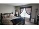 Charming bedroom featuring iron bed frame with floral patterned bedding at 118 Reunion Pl, Acworth, GA 30102