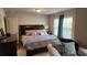 Relaxing bedroom with a large bed, window views, and soft furnishings at 118 Reunion Pl, Acworth, GA 30102