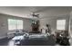 Cozy living room with a stone fireplace, ceiling fan, and abundant natural light at 118 Reunion Pl, Acworth, GA 30102