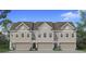 Charming exterior elevation of a new construction townhome featuring a two-car garage and professionally landscaped front yard at 190 Abbotts Crossing Cir, Conyers, GA 30094