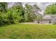The expansive backyard offers plenty of greenery, complemented by a well-kept exterior and trees at 2465 Hogan Rd, Atlanta, GA 30344