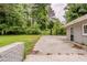 A spacious backyard featuring a parking pad and lush trees, adding a touch of nature to the property at 2465 Hogan Rd, Atlanta, GA 30344