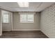 Finished basement with vinyl flooring, painted brick, and a bright window, bringing in light at 2465 Hogan Rd, Atlanta, GA 30344