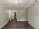 Spacious finished basement with painted brick and new floors; stairs lead to other parts of home at 2465 Hogan Rd, Atlanta, GA 30344