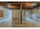 Exposed basement with white brick walls, unfinished ceiling, and concrete floors at 2465 Hogan Rd, Atlanta, GA 30344
