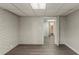 Finished basement with painted brick, neutral walls and floors and access to a full bathroom at 2465 Hogan Rd, Atlanta, GA 30344