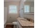 Bathroom showing updated vanity with granite top, new fixtures, and tub at 2465 Hogan Rd, Atlanta, GA 30344