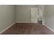 Bedroom with neutral walls and closet with view to a hall with wood floors at 2465 Hogan Rd, Atlanta, GA 30344
