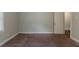 Neutral bedroom features carpeting and ample space; door leads to other areas of the home at 2465 Hogan Rd, Atlanta, GA 30344