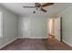Neutral bedroom featuring plush carpeting, ceiling fan, and convenient access to other areas at 2465 Hogan Rd, Atlanta, GA 30344