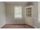 Bedroom featuring neutral walls and a corner cabinet, filled with natural light from the window at 2465 Hogan Rd, Atlanta, GA 30344
