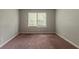 Bedroom featuring a window with views to trees and neutral walls at 2465 Hogan Rd, Atlanta, GA 30344