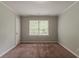 Bedroom with neutral walls, closet and window overlooking green trees at 2465 Hogan Rd, Atlanta, GA 30344