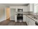 Modern kitchen showcasing stainless steel appliances, granite countertops, and ample cabinet space at 2465 Hogan Rd, Atlanta, GA 30344