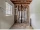 Unfinished room featuring exposed framing and a window at 2465 Hogan Rd, Atlanta, GA 30344