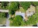 An aerial perspective reveals the home's roof, surrounded by mature trees and a well-manicured lawn at 6857 Womack Ct, Atlanta, GA 30360