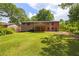 Large backyard with lush green grass and mature trees at 6857 Womack Ct, Atlanta, GA 30360
