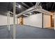 Unfinished basement offers plenty of potential with an open layout, painted walls, and blue carpet at 6857 Womack Ct, Atlanta, GA 30360