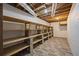 Basement storage room with wood shelving and vinyl flooring at 6857 Womack Ct, Atlanta, GA 30360