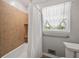 Cozy bathroom with tiled walls and bathtub with a window to the outdoors at 6857 Womack Ct, Atlanta, GA 30360