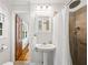 Bathroom featuring a pedestal sink and tiled shower with safety bar at 6857 Womack Ct, Atlanta, GA 30360