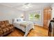 Cozy bedroom featuring hardwood floors, bright windows, and a comfortable chair at 6857 Womack Ct, Atlanta, GA 30360