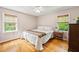 Bright bedroom featuring hardwood floors and tranquil views from multiple windows at 6857 Womack Ct, Atlanta, GA 30360