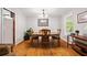 Cozy dining area with hardwood floors, traditional furniture, and a modern chandelier at 6857 Womack Ct, Atlanta, GA 30360