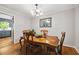 Classic dining room with wooden table, chandelier, and hardwood floors for elegant entertaining at 6857 Womack Ct, Atlanta, GA 30360