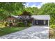 View of the home with a long driveway and a convenient covered parking area at 6857 Womack Ct, Atlanta, GA 30360