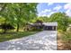Charming single-story home with a long driveway and a beautiful front yard surrounded by mature trees at 6857 Womack Ct, Atlanta, GA 30360
