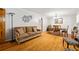 Bright living room and dining area featuring gleaming hardwood floors and neutral decor at 6857 Womack Ct, Atlanta, GA 30360