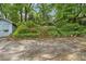 The backyard has a terraced wall, a shed, and plenty of green foliage at 1861 Ardmore Nw Rd, Atlanta, GA 30309