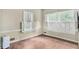 Bright bedroom featuring hardwood floors, white shutters, and neutral walls at 1861 Ardmore Nw Rd, Atlanta, GA 30309