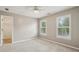 Bedroom with neutral walls, carpet flooring, lots of natural light, and a walk-in closet at 205 Devon Downs Pl, Alpharetta, GA 30005