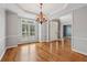 Bright dining room featuring hardwood floors, natural light, and views into the entry at 205 Devon Downs Pl, Alpharetta, GA 30005