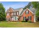 Stately brick residence showcasing a lush front yard and timeless design elements at 205 Devon Downs Pl, Alpharetta, GA 30005